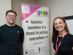 photo of 2 people with a banner