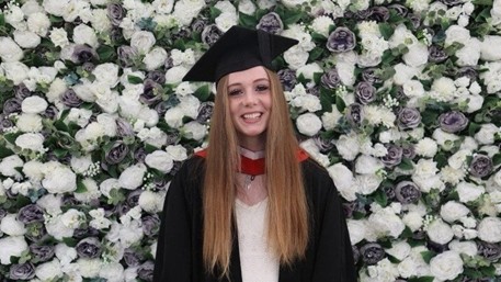 SPARK-Iesha-graduation a woman in academic dress